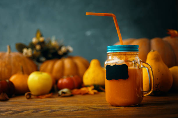 istock Pumpkins juice in bottles with pumpkins. 1180702549