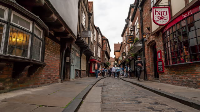 Time-lapse: Tourist Pedestrian Commuter Crowd at York shamble shopping area in York England Uk.
