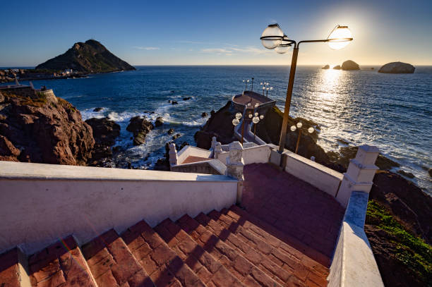 Centennial Walk in Mazatlan, Mexico A wide angle view of a stair case leading down to an overlook with the lighthouse in the background in Mazatlan, Mexico mirador stock pictures, royalty-free photos & images