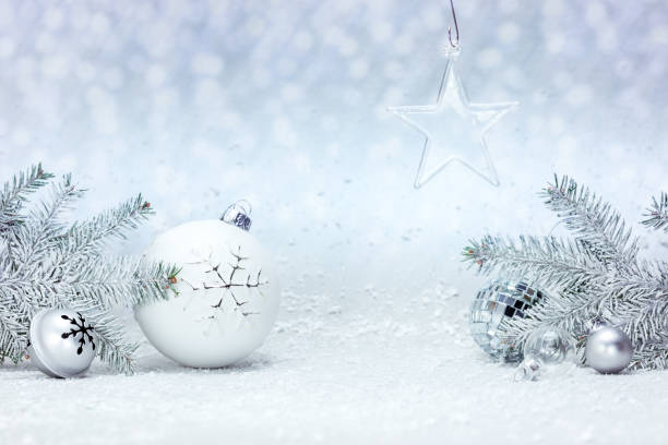 istock fir tree branches and christmas decorations against white snow background 1180718532