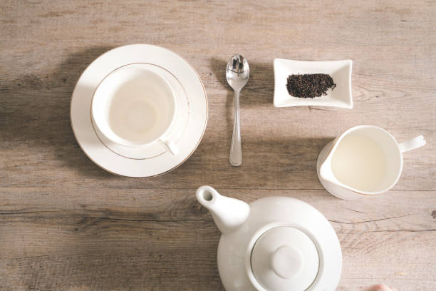 istock Composition with tea cup, tea pot and tea leaves on wooden background, flat lay 1180718794