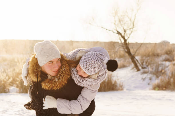 istock Teens brother and sister having fun snow in winter 1180721992