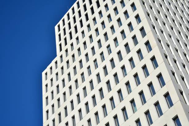 istock Modern office building detail. Perspective view of geometric angular concrete windows on the facade of a modernist brutalist style building. 1180726473