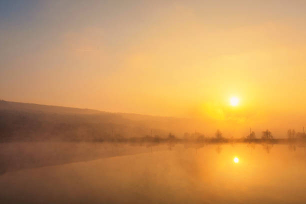 istock Sunrise over foggy lake. 1180726675