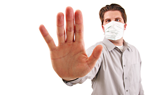 a man holding up his hand to stop a disease isolated on white.