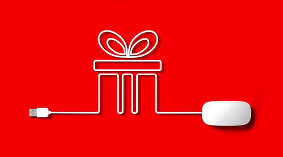 White mouse cable forming a gift box on red background. Horizontal composition with copy space.