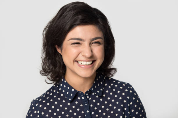 istock Happy indian girl posing in grey studio background 1180735487