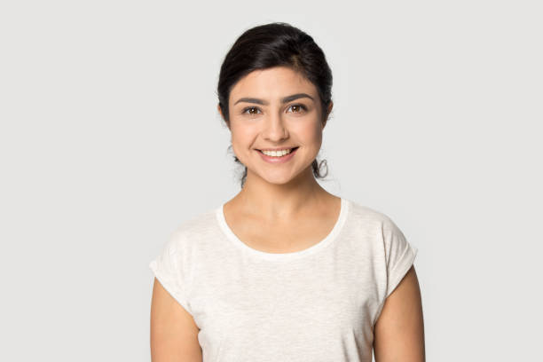 headshot portrait of smiling indian girl posing in studio - shirt lifestyles close up cheerful imagens e fotografias de stock