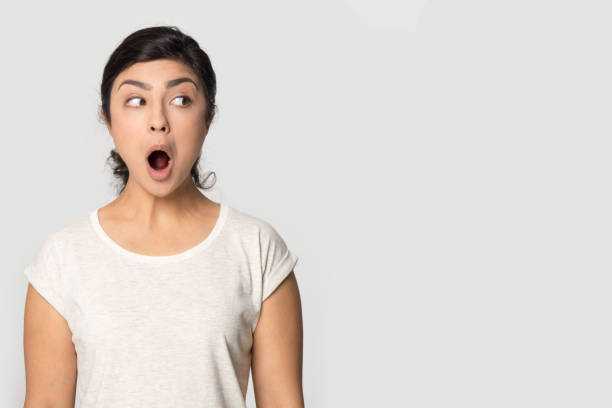istock Shocked indian girl amazed looking aside on blank copy space 1180735930