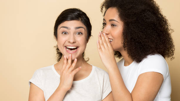 istock Happy multiethnic millennial girlfriends gossip share secrets 1180736285