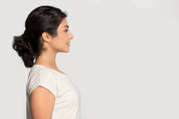 istock Ethnic young woman look at blank copy space aside 1180736355