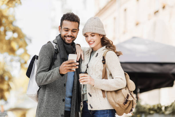 istock Happy man and woman using smartphone together 1180739424