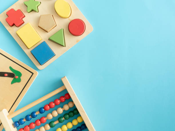 istock kids learning concept with stacking toys on blue table background. 1180739560