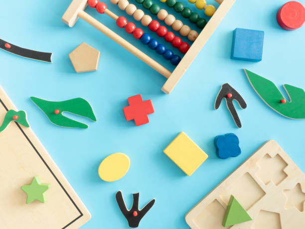 istock kids learning concept with stacking toys on blue table background. 1180739562