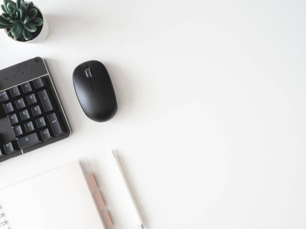 istock top view of office desk table with keyboard, plastic plant, digital camera and keyboard on white background, graphic designer, Creative Designer concept. 1180739586