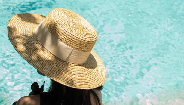 istock A woman is sitting beside the pool 1180739599