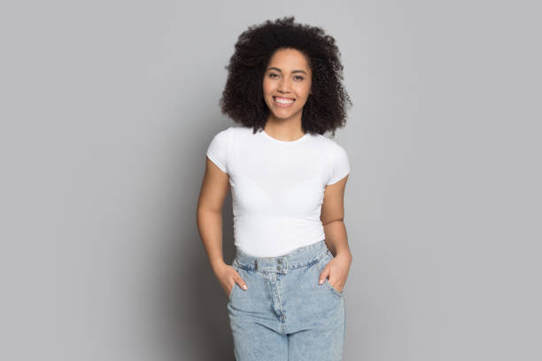 istock Smiling biracial millennial girl posing on grey background 1180739814