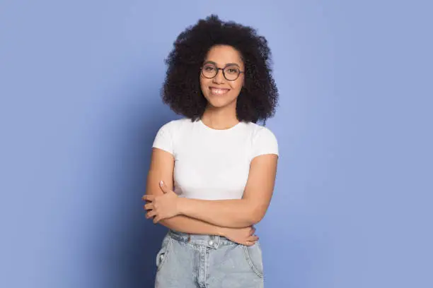 Photo of Smiling african American girl in glasses posing in studio
