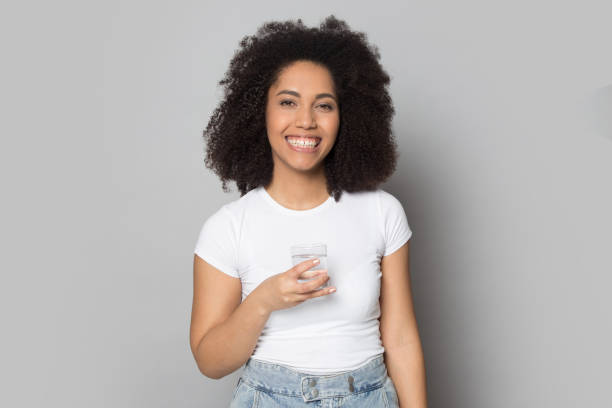 istock Smiling biracial girl recommend drinking pure water 1180740395