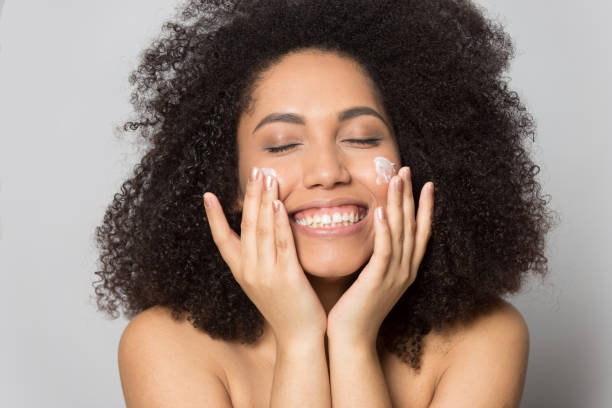 istock Happy biracial young woman preform skincare routine 1180740419