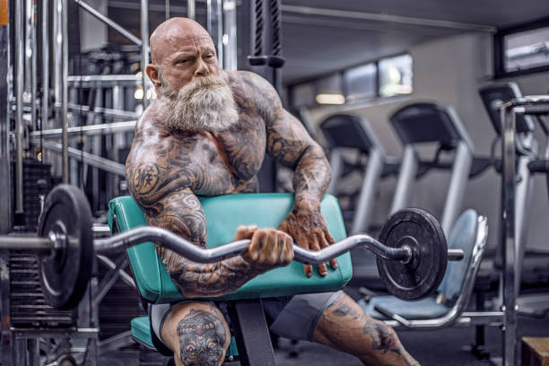 istock Tattooed Senior Man During Gym Workout 1180742226