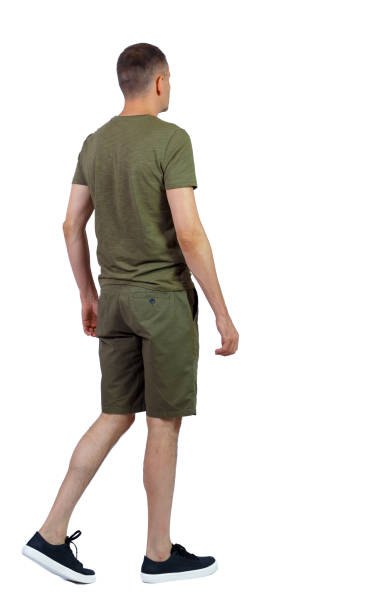 istock Back view of going handsome man in shorts. 1180742923