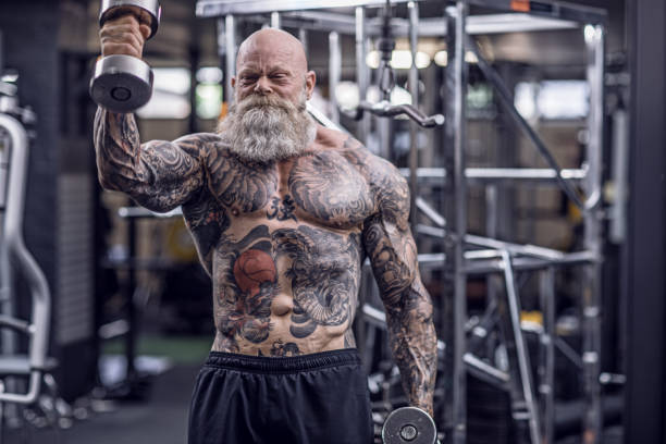 istock Tattooed Senior Man During Gym Workout 1180742984