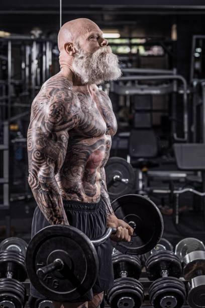 istock Tattooed Senior Man During Gym Workout 1180742986
