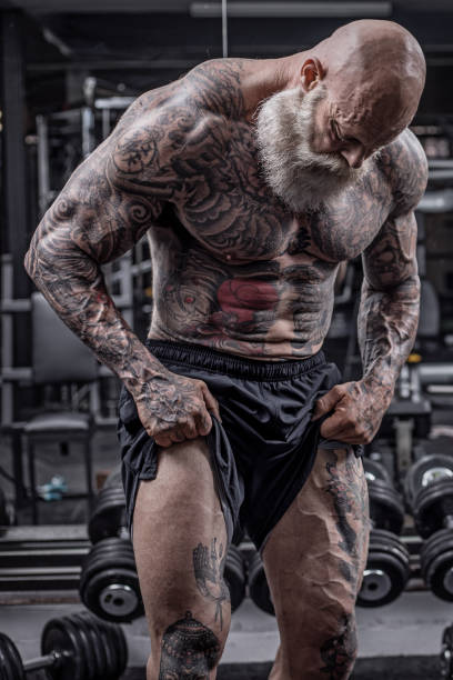 istock Tattooed Senior Man During Gym Workout 1180743092