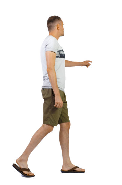 istock Back view of going pointing man in shorts. 1180743121