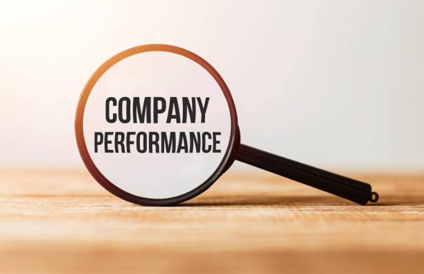 istock Magnifying glass with text Company Performance on wooden table. 1180743965
