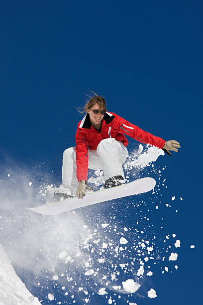 istock Female Snowboarder Flying In The Air 118074653