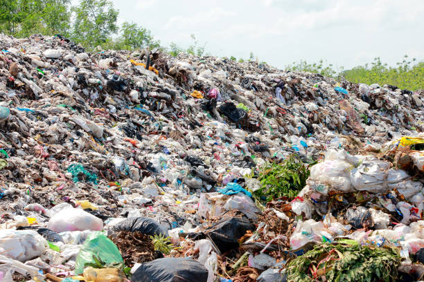 istock Mountain garbage, large and degraded garbage pile, Pile of stink and toxic residue, waste plastic bottles and other types of plastic waste site in trash dump or landfill. Pollution concept. 1180748708