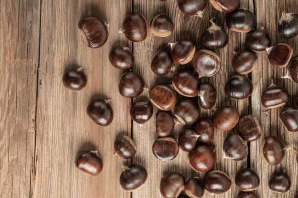 istock ripe and fresh chestnuts on wooden table with copy space 1180751587