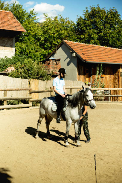 istock Young man riding a horse 1180751630