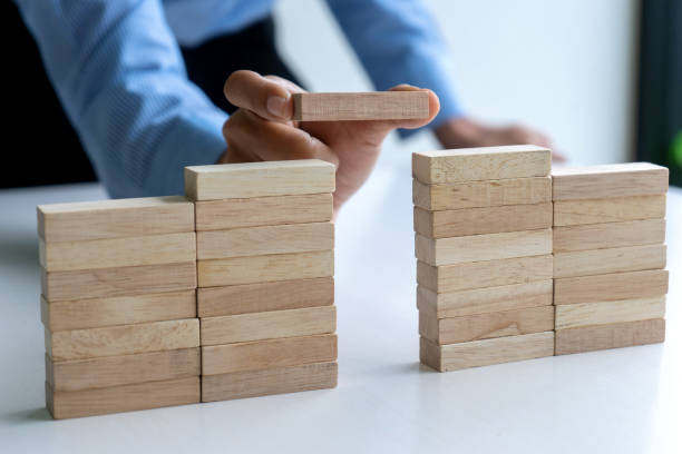 istock Young businessman try to build wall and tower 1180751691
