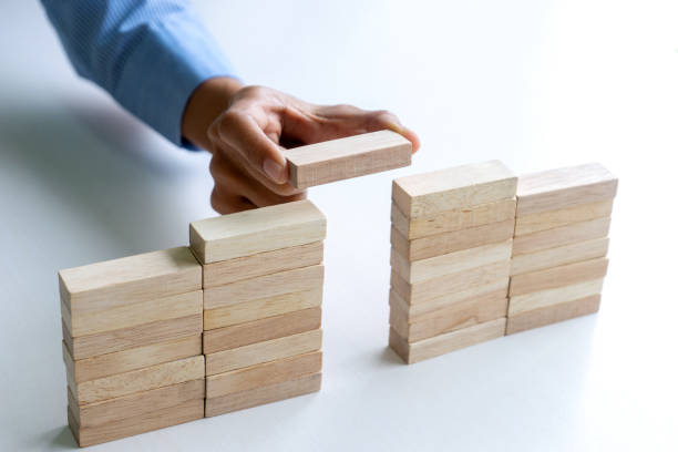 istock Young businessman try to build wall and tower 1180751698