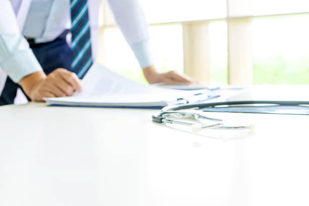 istock Doctor stand on the table with x ray film , 1180751729