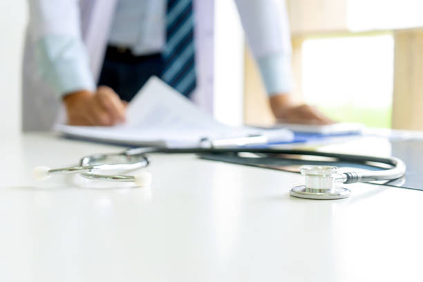 istock Doctor stand on the table with x ray film , 1180751766