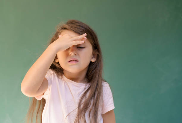 Little girl having a headache stock photo
