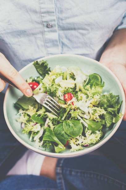 istock Fresh summer salad in bowl with lettuce, tomatoes, onions and cucumbers 1180754468