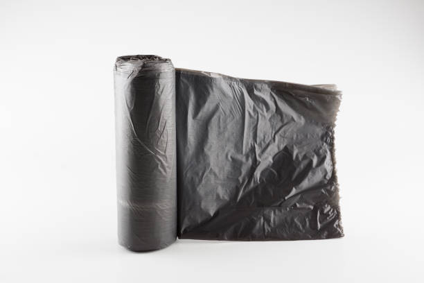 istock roll of trash bags isolated on white background 1180755970