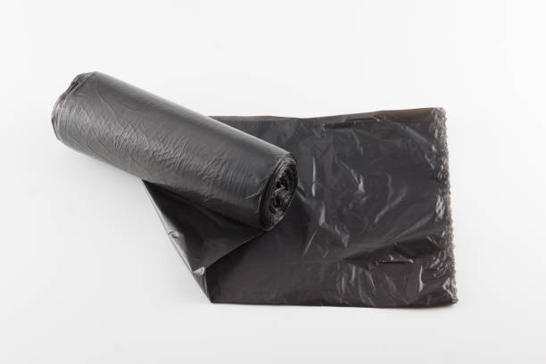 istock roll of trash bags isolated on white background 1180756038