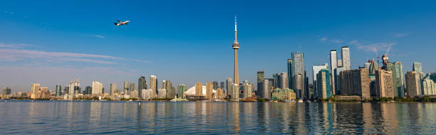 istock Aeroplane flying past the Toronto skyline over the harbor 1180758215