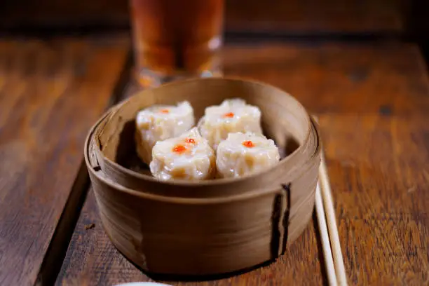 Photo of Steamed dumplings Dim Sum on wooden table