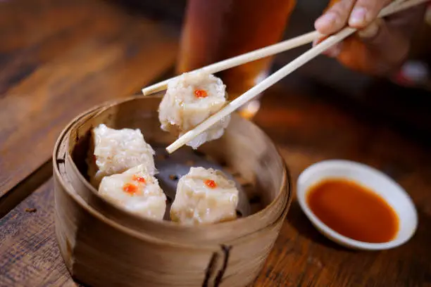 Photo of Dim Sum Chinese traditional food on wooden table