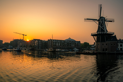 Sunrise over a canal at a windmill in the Netherlands Amsterdam in summer