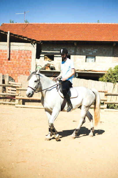 istock Young man riding a horse 1180762914