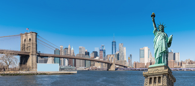 Panorama Statue of liberty with New York background of Brooklyn bridge and lower manhattan skyscrapers bulding in New York State NY , USA