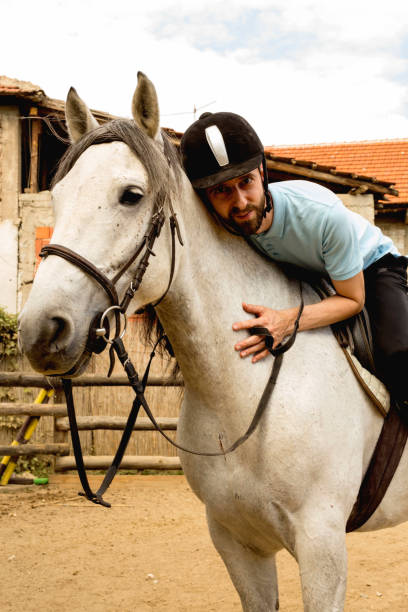 istock Young man riding a horse 1180763031